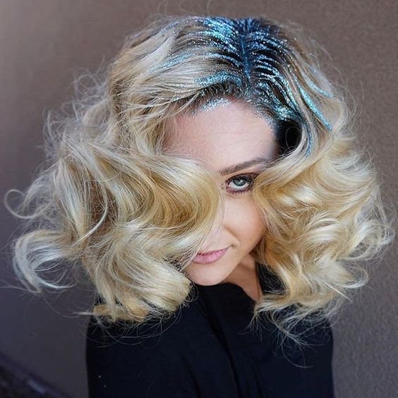 Model with a wavy long bob with glitter highlighting her part