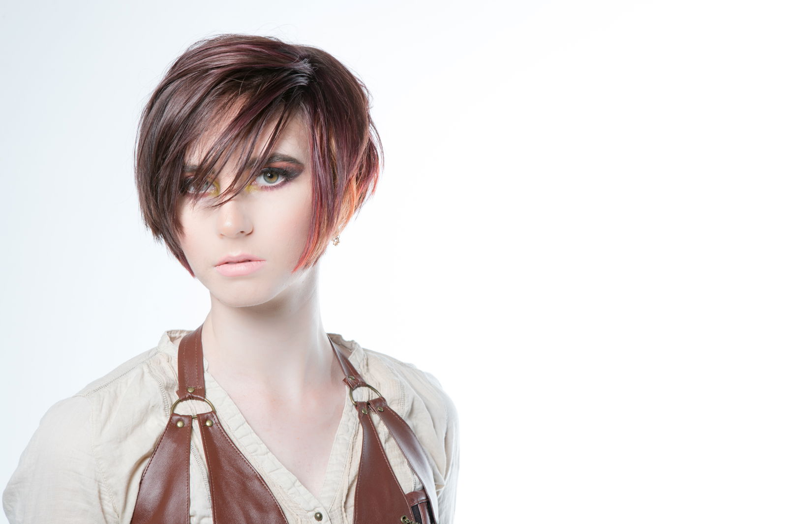 Model with a pixie cut that has orange highlights at the ends