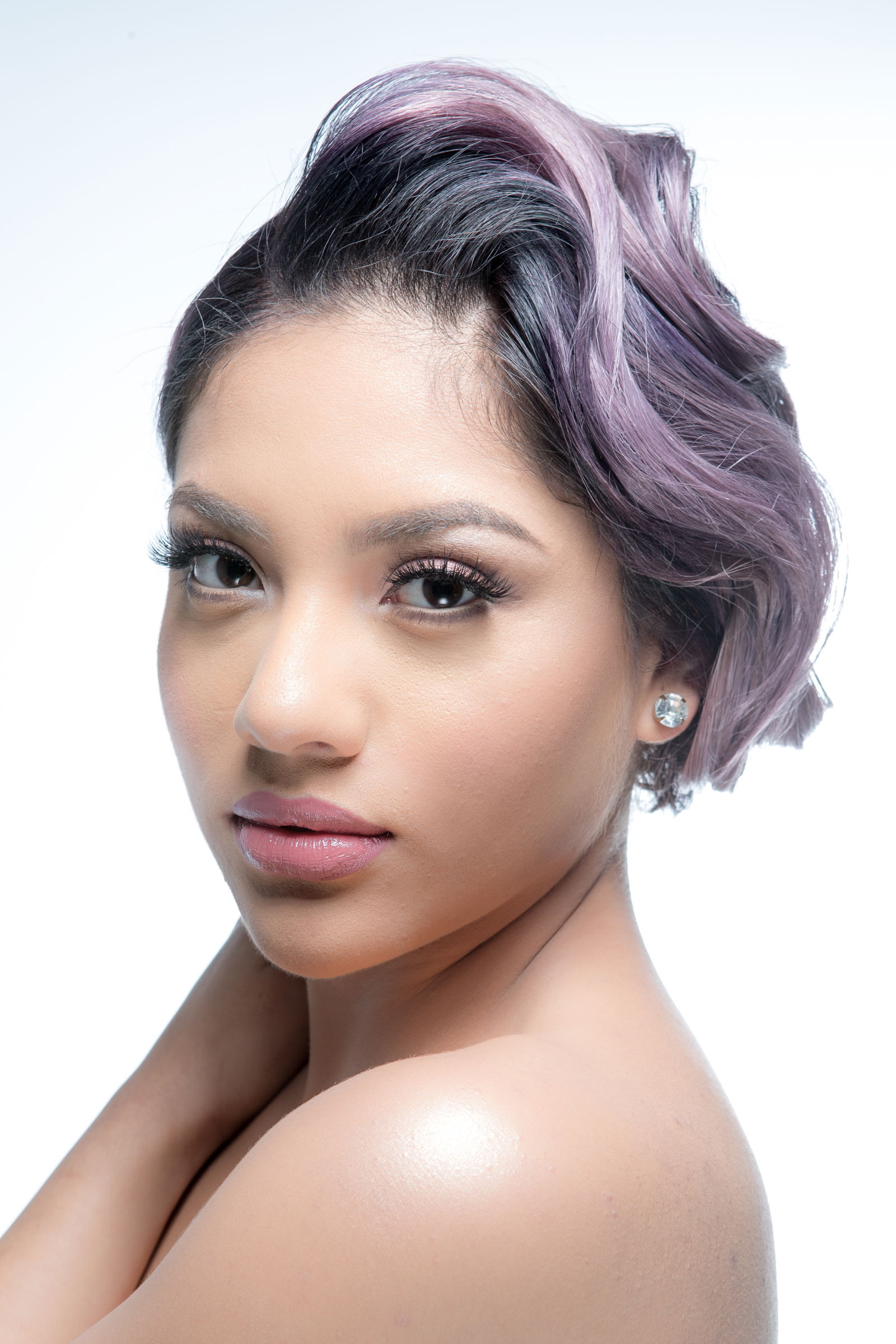 Model with pastel-lilac hair that is swept up in a wavy updo