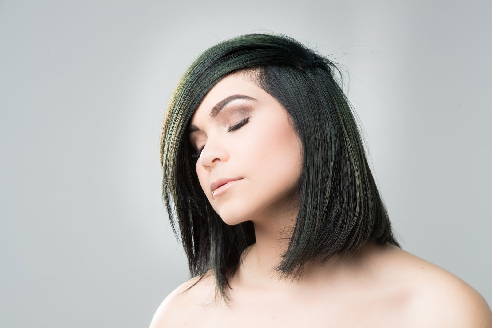 Model showing a shoulder-length bob with a dark forest-green color.
