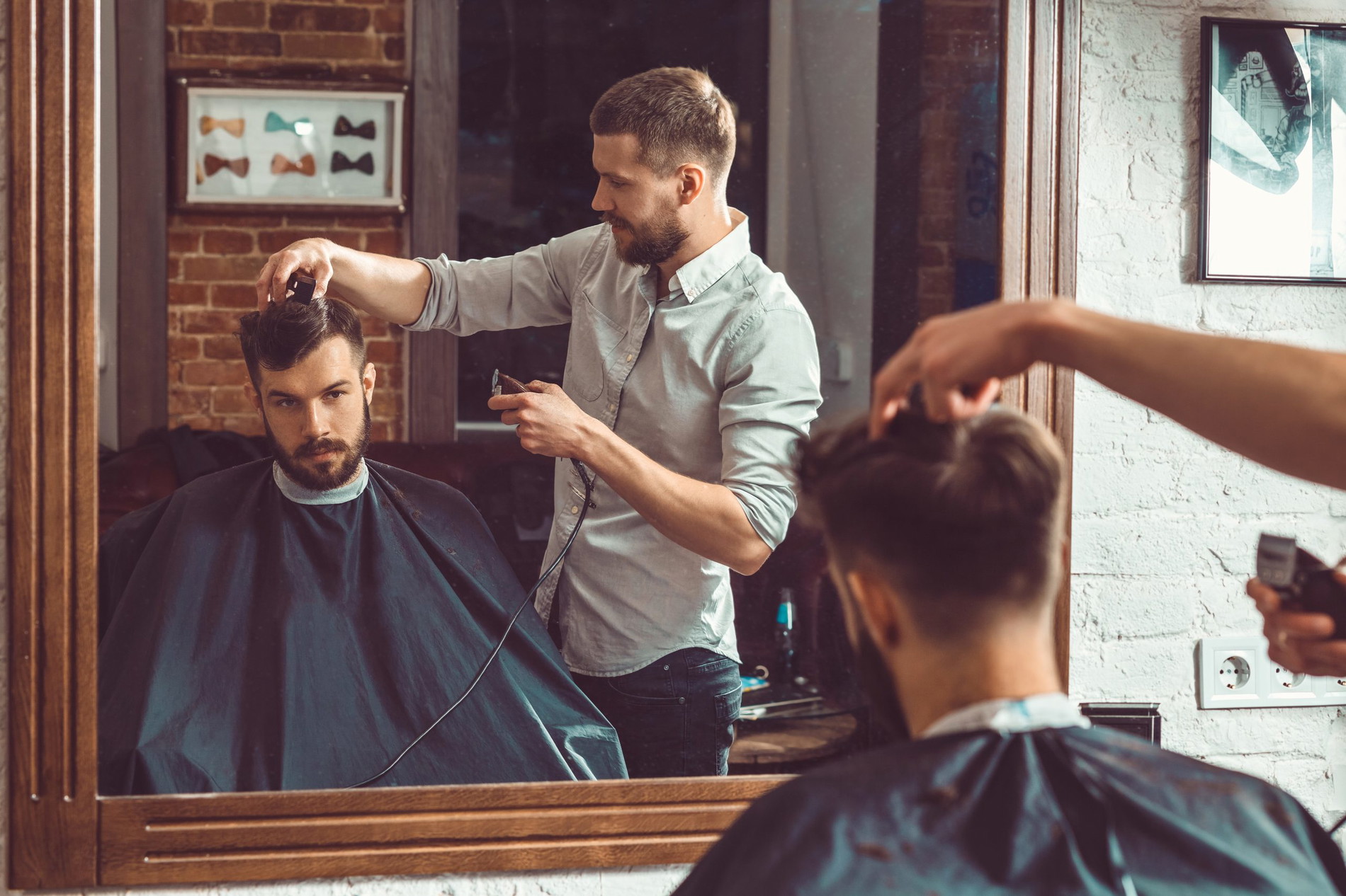 Man cutting another mans hair at a barber shop
